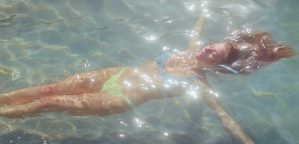 girl floating in a pool of water